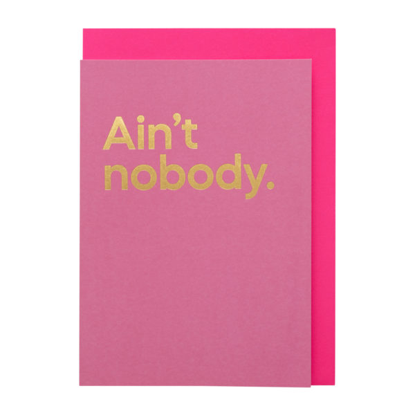 A pink card with 'Ain't nobody' printed in bold gold text, with a pink envelope
