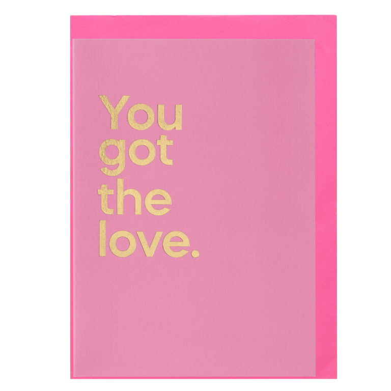 A pink greeting card that reads 'You got the love' in gold text