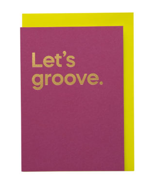 A pink card with 'Let's groove' printed in bold gold text, with a yellow envelope